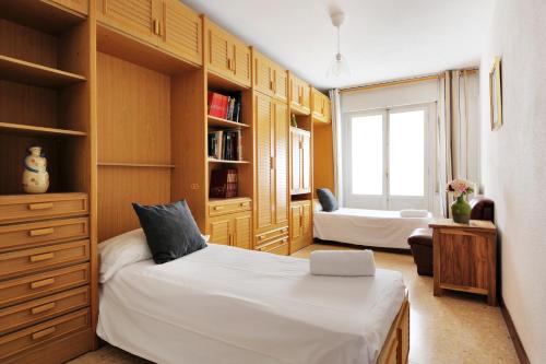 a bedroom with a bed and a book shelf at TorreNueva in Zaragoza