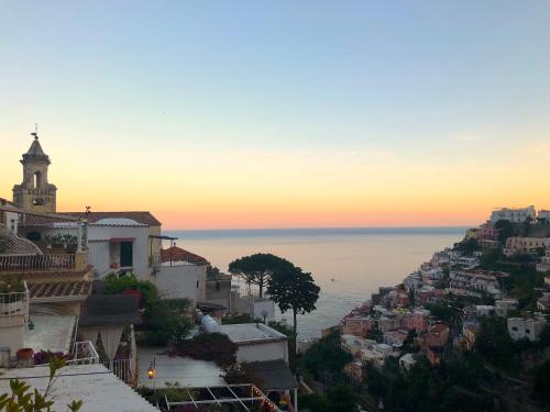 a view of the ocean from a city at sunset at Villa Mary Suites in Positano