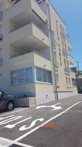 a building with a car parked in front of it at Apartment Zeljkica - Villa Sunce in Senj