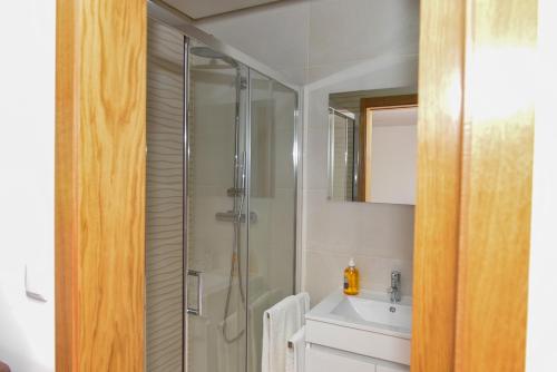 a bathroom with a shower and a sink at Casa Encosta do Rio-ferias no Gerês in Vieira do Minho