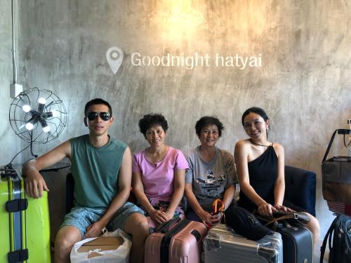 a group of people sitting with luggage in a room at Goodnight Poshtel + Free Netflix in Hat Yai