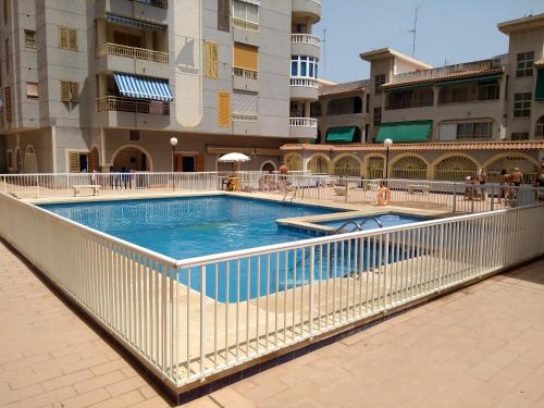 a swimming pool in the middle of a building at Apartamento Flamenco in Torrevieja