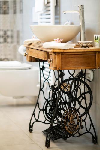 a bathroom vanity with a sink on a table at Benaco36 in Torri del Benaco