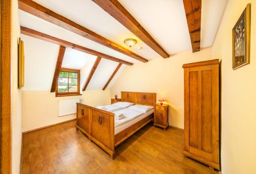a bedroom with a bed and a dresser at Penzion Prelat in Český Krumlov