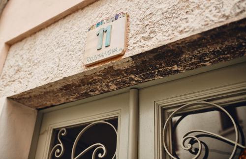 a building with a sign above a door at Apartment Artemus Studio Rozmanova in Piran
