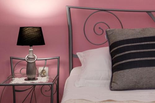 a bedroom with a bed with a lamp on a table at Apartment Ambroz in Vela Luka