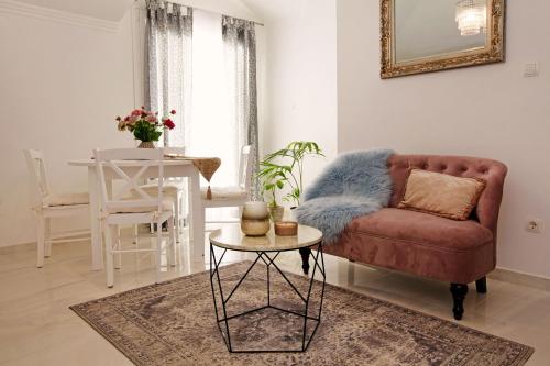 a living room with a red couch and a table at Apartment Ambroz in Vela Luka