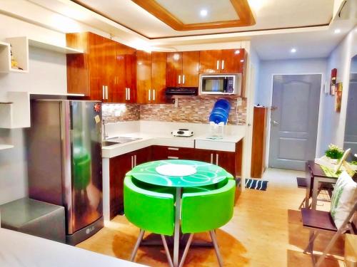 a kitchen with a green stool in a kitchen at ARC Home Rental at San Remo Oasis in Cebu City