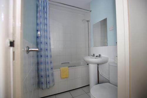 a bathroom with a sink and a toilet and a shower at Laguna Hotel in Bournemouth