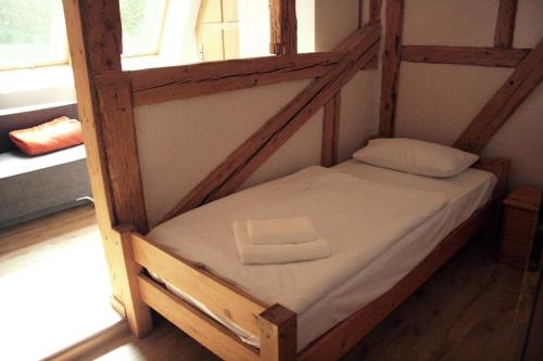 a small bunk bed in a room with a window at Karczma Bełty in Glinno