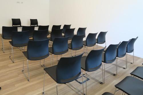 a row of black chairs in a room at Best Western Hotel Corsi in Torrimpietra