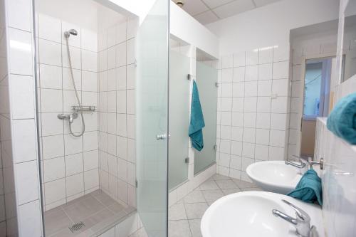 a bathroom with a shower and a sink at MINIDORM ROOMS IN HEART OF CITY CENTER in Maribor