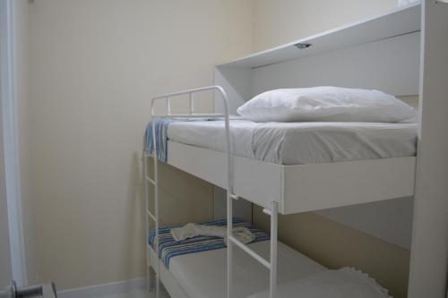 a couple of bunk beds in a room at Sun Paradise - JTR in Maceió