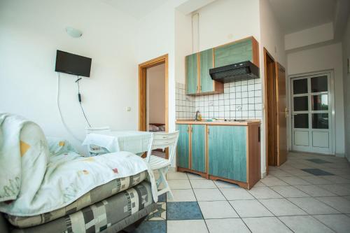 a kitchen with a bed and a sink in a room at Apartments Pušić in Omiš