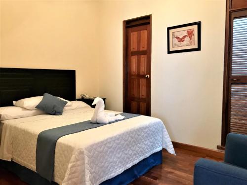 Una cama o camas en una habitación de Hotel Belvedere
