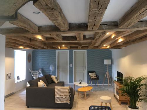 a living room with a couch and a table at Berlingot in Amboise