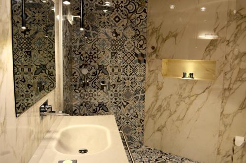 a bathroom with a sink and a shower at Ferhadija 31 Old town Sarajevo in Sarajevo