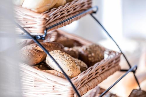 a basket filled with different types of bread at B&B Boutique Apartment Oberwiesen in Brunico