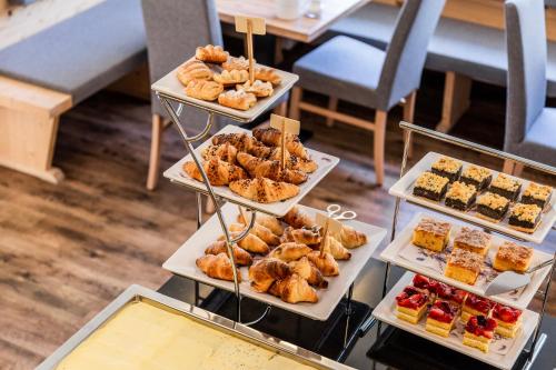 a display of different types of pastries and desserts at B&B Boutique Apartment Oberwiesen in Brunico