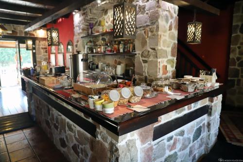 a bar with food on a stone wall at Monastiri Guesthouse in Kalabaka