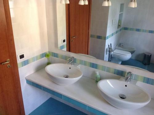 a bathroom with two sinks and a toilet at B&B DA CHIARA SEA SIGHT in Sorrento