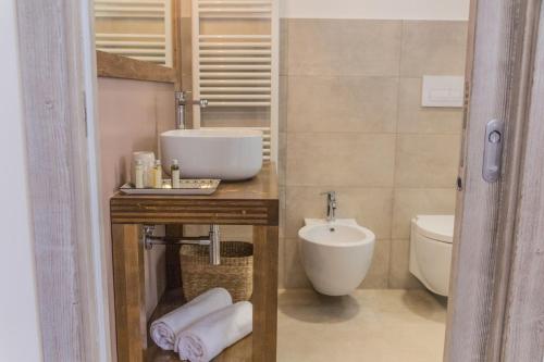 a bathroom with a sink and a toilet at Trulli Nannì in Locorotondo