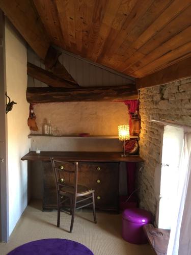 a room with a desk and a chair in a room at Zen au Marais Hammam Massages in Maillezais