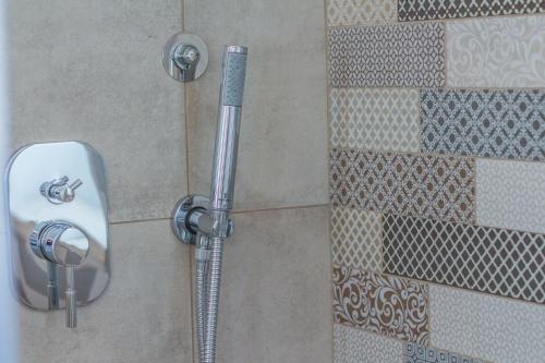 a shower with a shower head in a bathroom at Trulli Nannì in Locorotondo