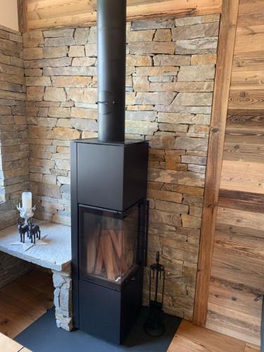 a fireplace in a room with a brick wall at Palace Luxury Wellness Apartment and Boutique Hotel Ski-in-out in Saas-Fee