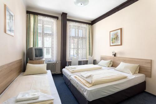 Postel nebo postele na pokoji v ubytování Penzion Hotel Morrison