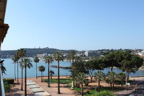 - une vue sur un parc planté de palmiers et une étendue d'eau dans l'établissement STUDIO STANDING BORD DE MER ET VUE, à Antibes