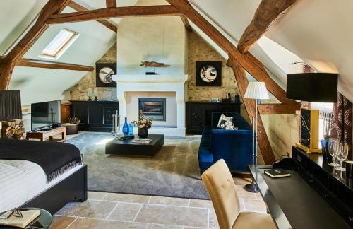 a bedroom with a bed and a fireplace at Moulin Royale in Saint-Etienne-Roilaye
