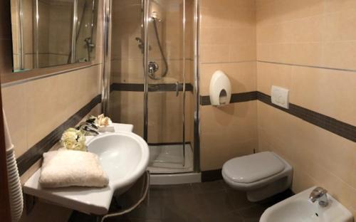 a bathroom with a sink and a shower and a toilet at Europalace Hotel Todi in Todi