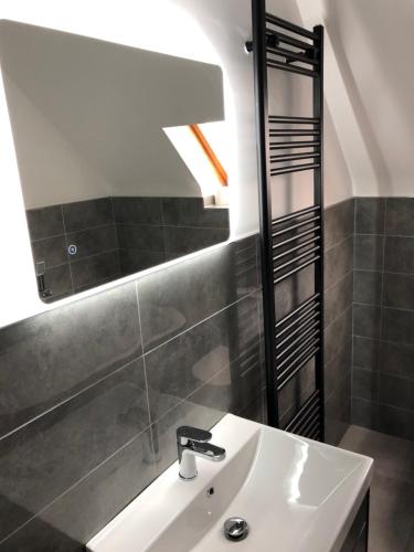 a bathroom with a sink and a mirror at No. 7 Lissadell Holiday Home in Portstewart