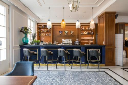a bar in a restaurant with blue counter and chairs at Palace Art Hotel Pezinok in Pezinok