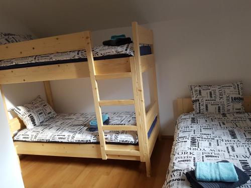 two bunk beds in a room with two beds at Apartma Katja in Mojstrana