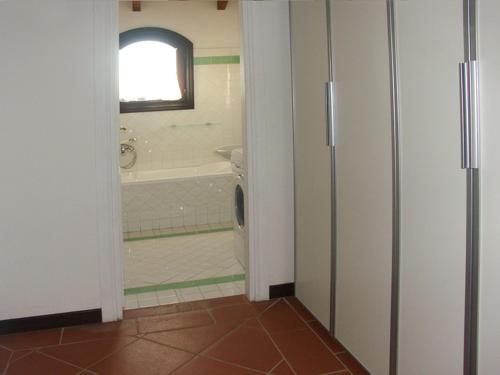 a bathroom with a tub and a toilet and a sink at Villa Picasso A in Stintino