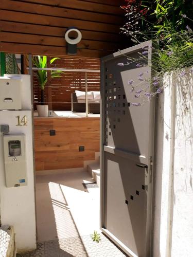 an open door to a kitchen with a refrigerator at Los Patios de Santander in Santander