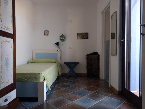 a bedroom with a bed and a tiled floor at Casa Blu in Linosa