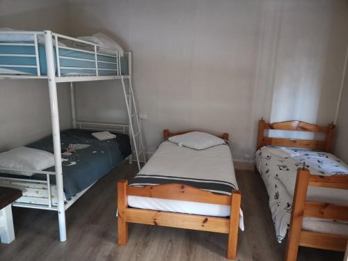 a bedroom with two bunk beds and a bed at Maison de campagne à 1h20 de PARIS in Saint-Hilaire-les-Andrésis