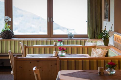 a restaurant with tables and chairs and a window at Ferienpension Steiner in Weerberg