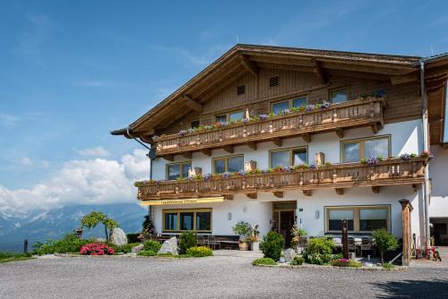 a house in the mountains with a balcony at Ferienpension Steiner in Weerberg