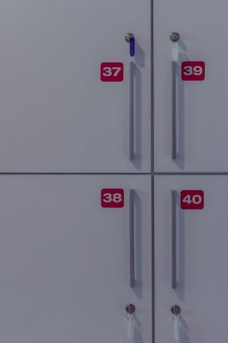 a row of white cabinets with red numbers on them at ART Hostel in Tirana