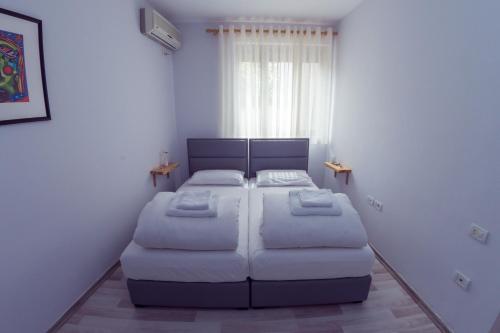 a small bedroom with a bed and a couch at ART Hostel in Tirana