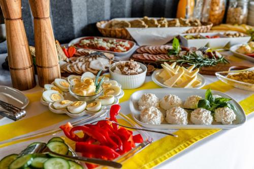 a table with appetizers and other food on it at Pajda Mazur - Ośrodek wypoczynkowy in Stare Jabłonki