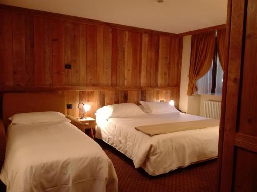 Ένα ή περισσότερα κρεβάτια σε δωμάτιο στο Le Miramonti Hotel Restaurant & Wellness