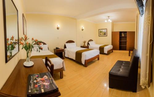 Habitación de hotel con 2 camas y sofá en Santa Marta Hotel, en Arequipa