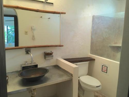 a bathroom with a sink and a toilet at Maria's Kan Kin in Isla Mujeres