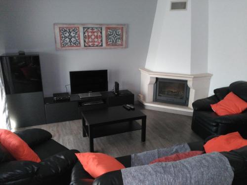 a living room with two couches and a fireplace at Apa Quinta de Fora in Viseu