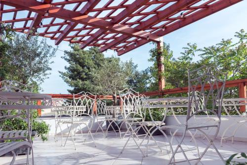 a group of chairs and tables on a patio at ART Hostel in Tirana